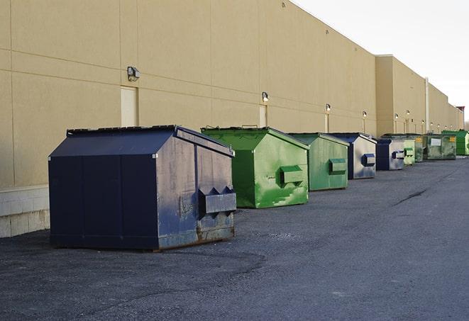 construction dumpsters on a worksite surrounded by caution tape in Avon, CT